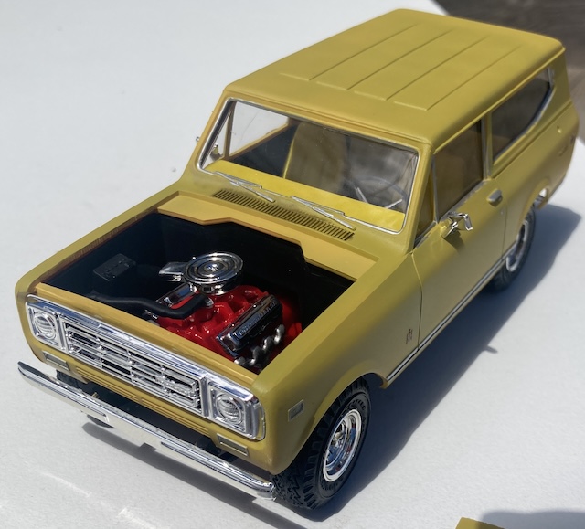 The truck's engine bay is exposed as the hood as been removed.