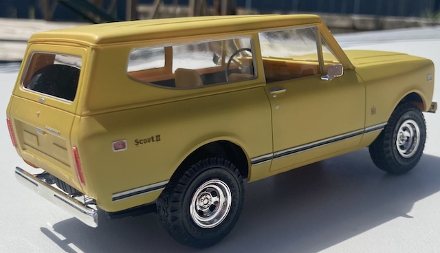 The truck is driving away from the viewer, ready for some exciting off-road adventure.