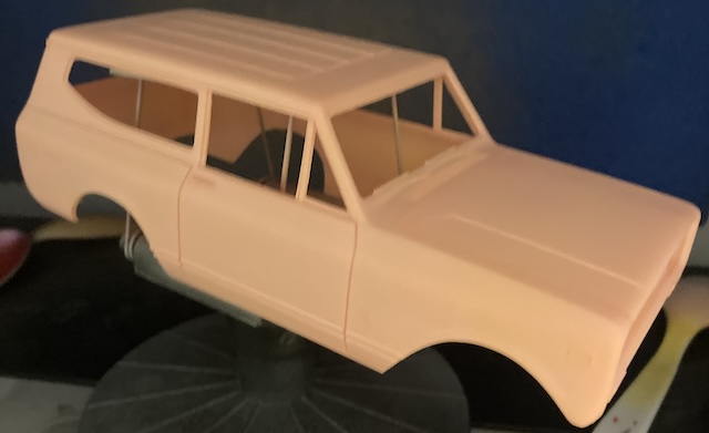 A very blurry and dark picture of the body, which is now in pink surfacer.