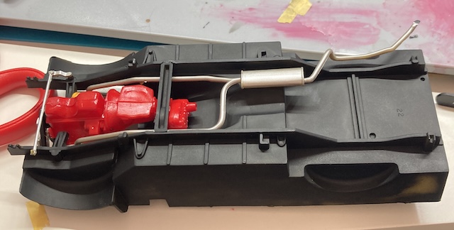 The transmission crossmember is holding the transmission/transfer case in place.