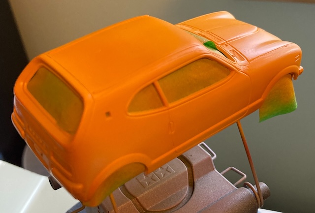 The Honda Z is now in daylight, and appears much more orange.
