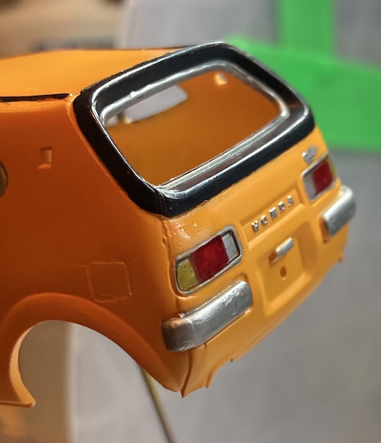 The tail lights, consisting of a turn signal, brake light, and reverse light.