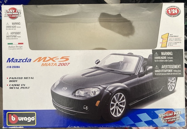 The box that the kit came in. The body is no longer visible through the window, having been partially assembled and thrown loosely back into the box.