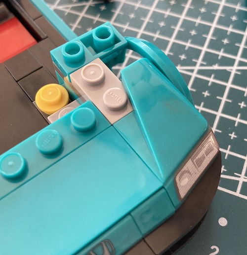 The left side fender has greasy brown dirt on it.