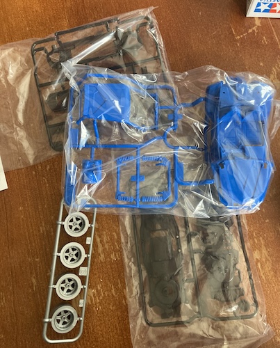 The several baggies: blue body parts, grey wheels, and a transparent grey chassis.