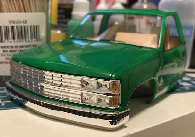 The headlights and grille are in, but the black line on the front of the bumper is somewhat patchy and uneven.