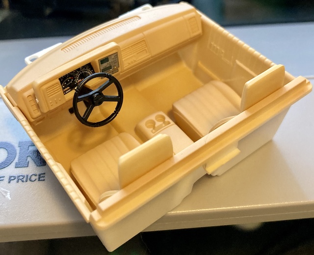The interior tub is put together. You can tell an obvious white sprue mark on the left side, and all the stickers are crooked.