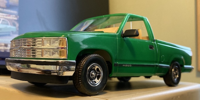 The truck is sitting on top of a Macintosh SE.