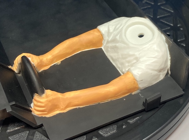 The arms are painted, although there's little flecks of overpainting here and there on the black surface.