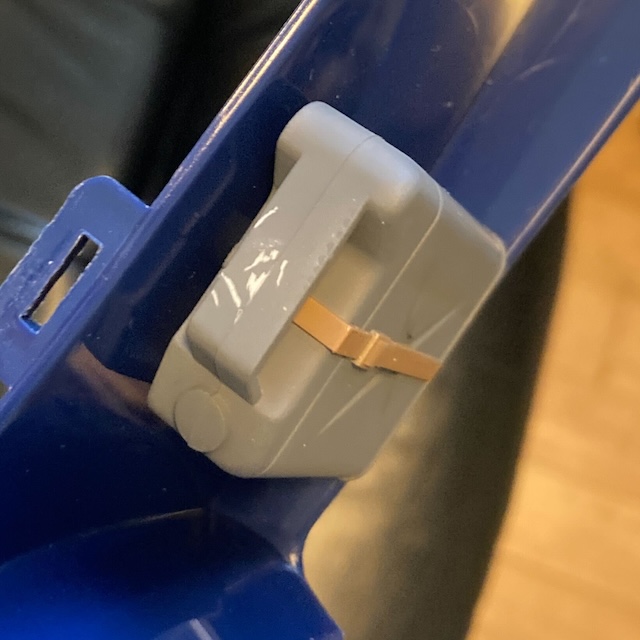A ton of paint is missing from the handle of the gas can, exposing shiny white plastic beneath.
