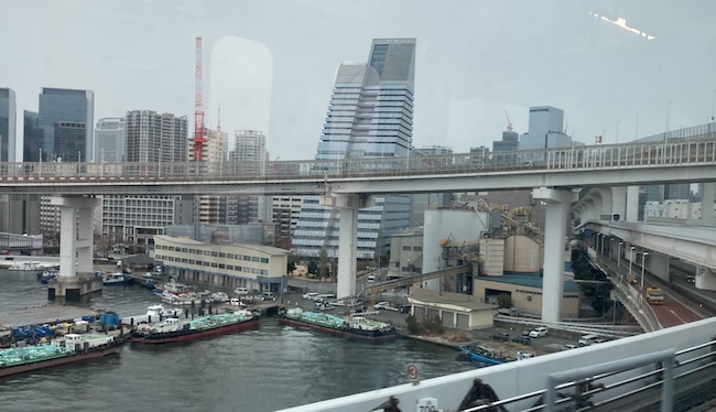 Yokoso Rainbow Tower is seen from the Yurikamome robot(!) train coming into the Tokyo Bay.