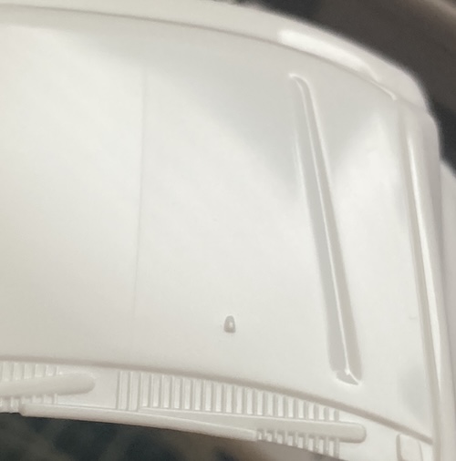A faint part line is on the hood. Check out the sharply defined windshield washer sprayer nozzles.
