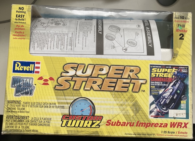 The big yellow "Super Street" branded box, with the Subaru WRX hidden from view.