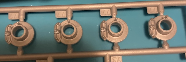 All four brakes are identical, with relatively tiny rotors and huge calipers.