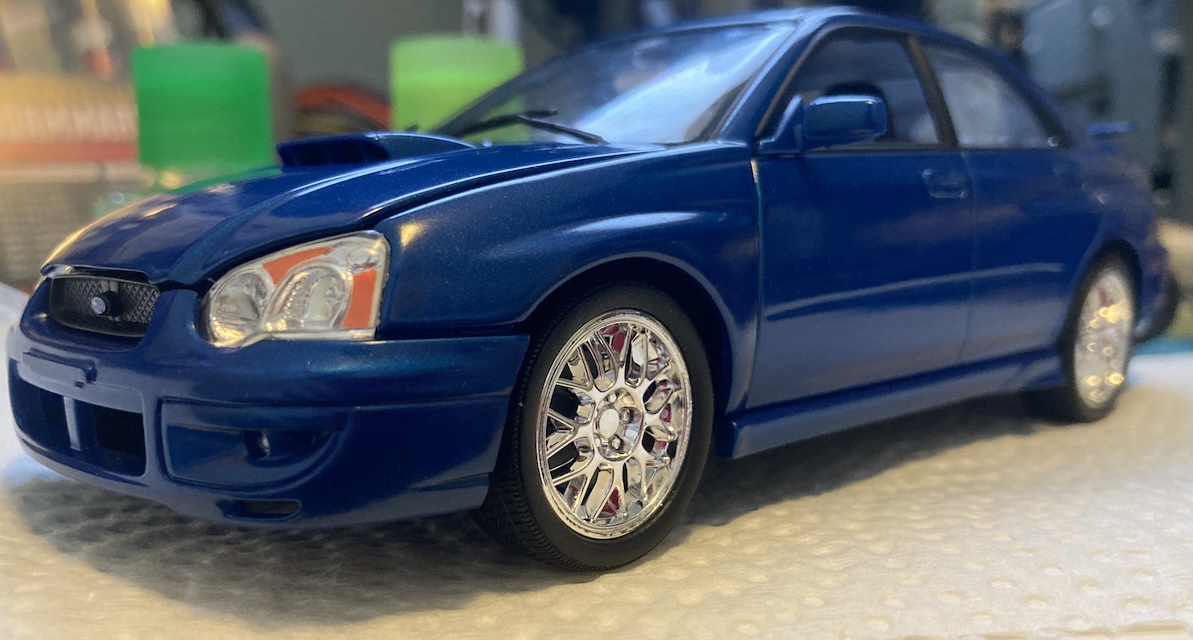 The front left corner of the car. You can just barely see the reflection of those nice red calipers.