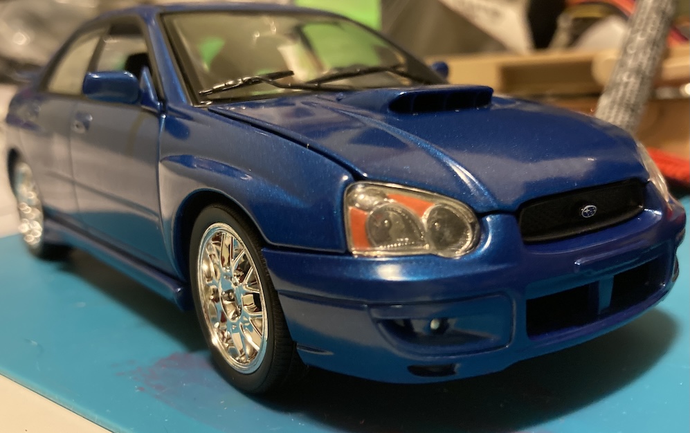 The front right corner of the car shows that the hood gap is not quite right. The "T" shaped plastic bit inside the bumper opening is also painted body colour instead of black.