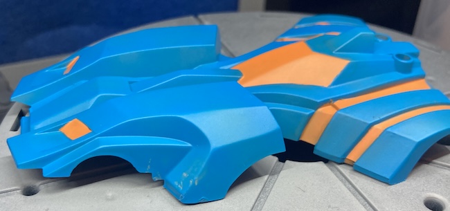 There's a smear in the quarter's blue paint showing some exposed orange-ish colour.