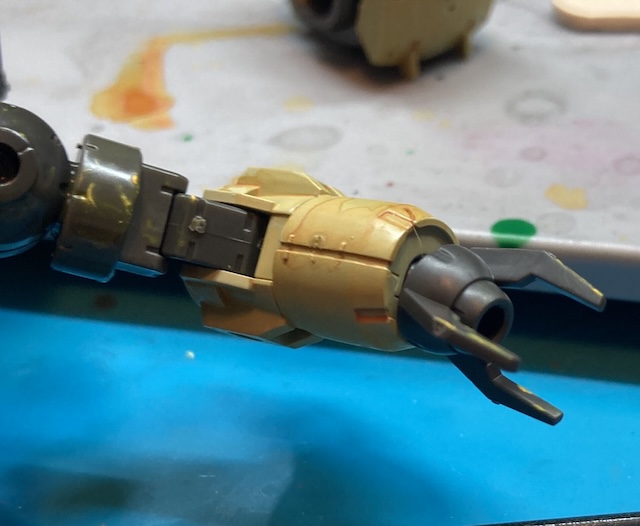 Some yellow paint is splashed sporadically around the joints and claw on the left arm.