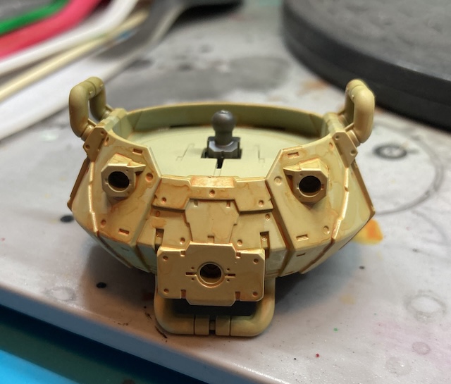 The upper torso is covered in rusty orange gunk with no apparent rhyme or reason.