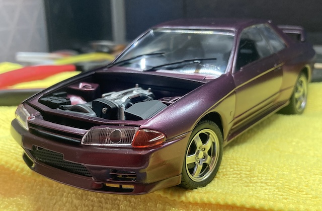 The headlights are installed, although the passenger-side headlight is popped up a little bit.